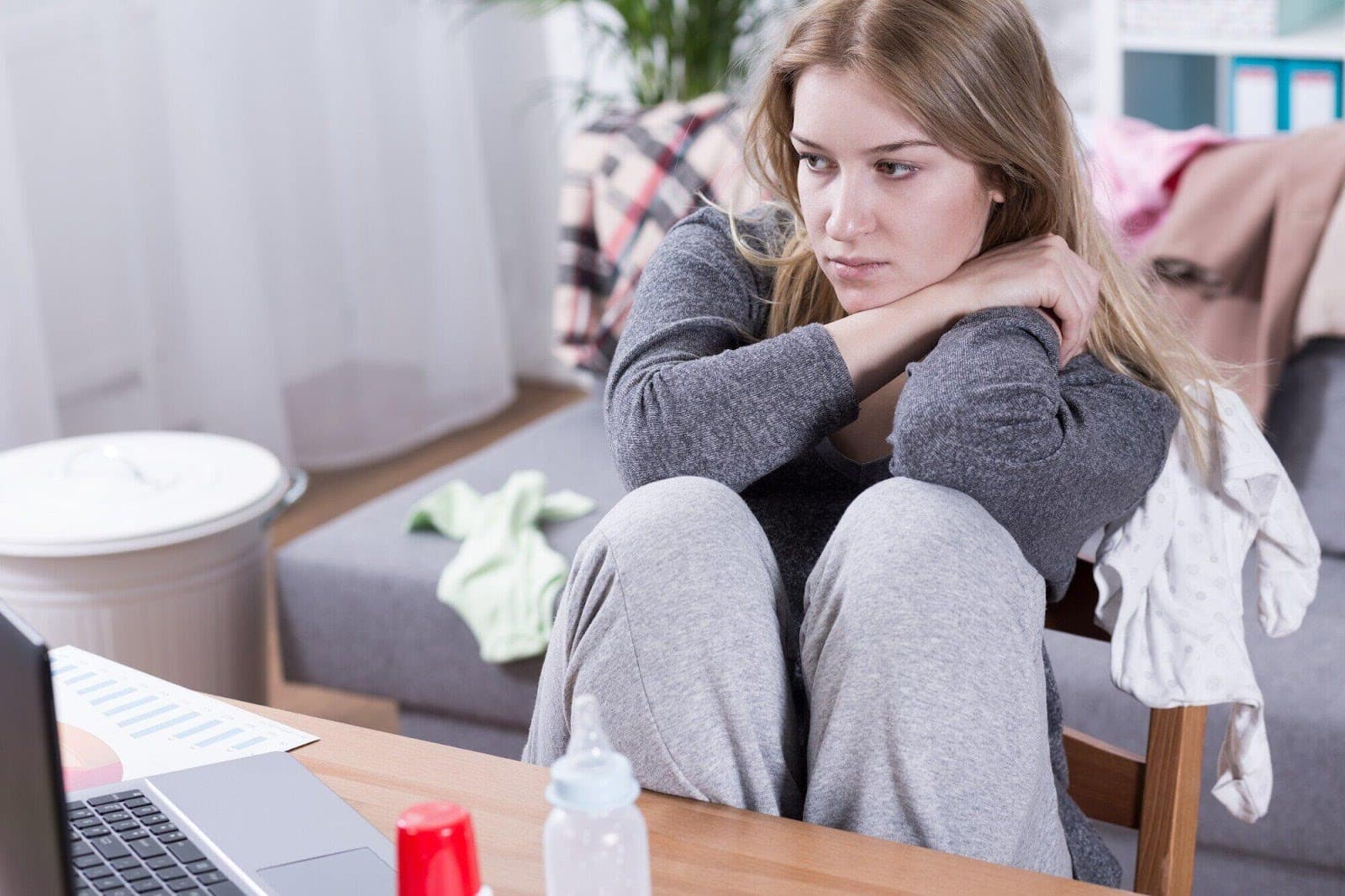 Sad-looking woman sitting at a desk
